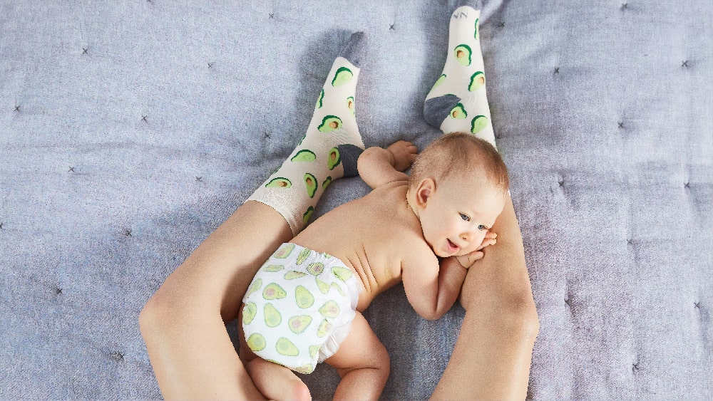 Baby on a bed with a diaper